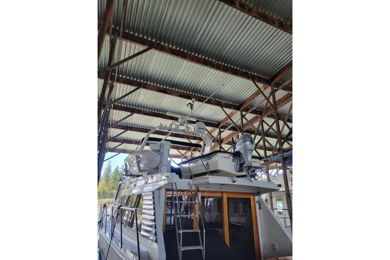 Sumptin Special Yacht Photos Pics 1990 Ocean Alexander 520 Pilothouse yacht docked under a metal roof.