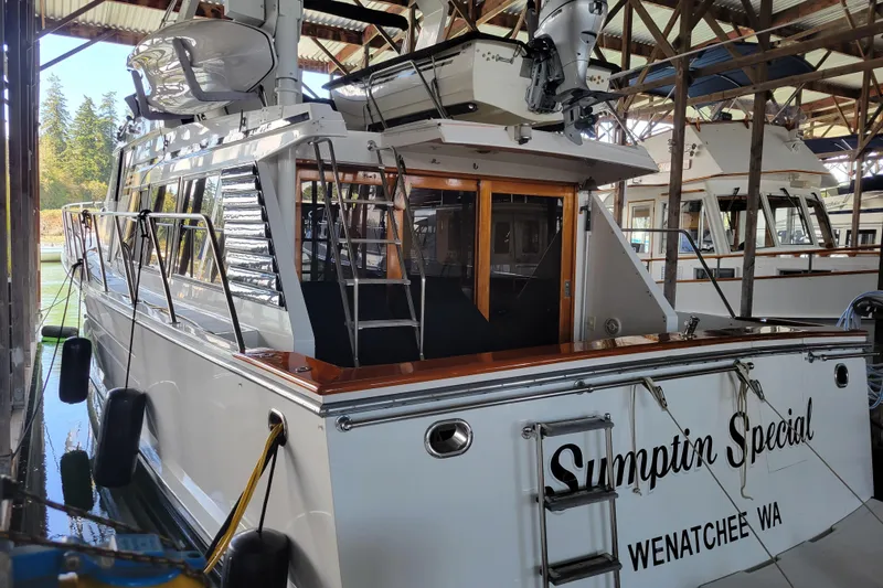 Sumptin Special Yacht Photos Pics 1990 Ocean Alexander 520 Pilothouse docked in a marina, featuring sleek design and wooden accents.