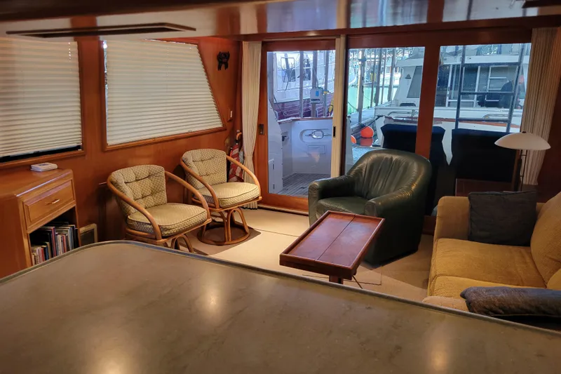 Sumptin Special Yacht Photos Pics Interior of 1990 Ocean Alexander 520 Pilothouse with cozy seating and large windows.