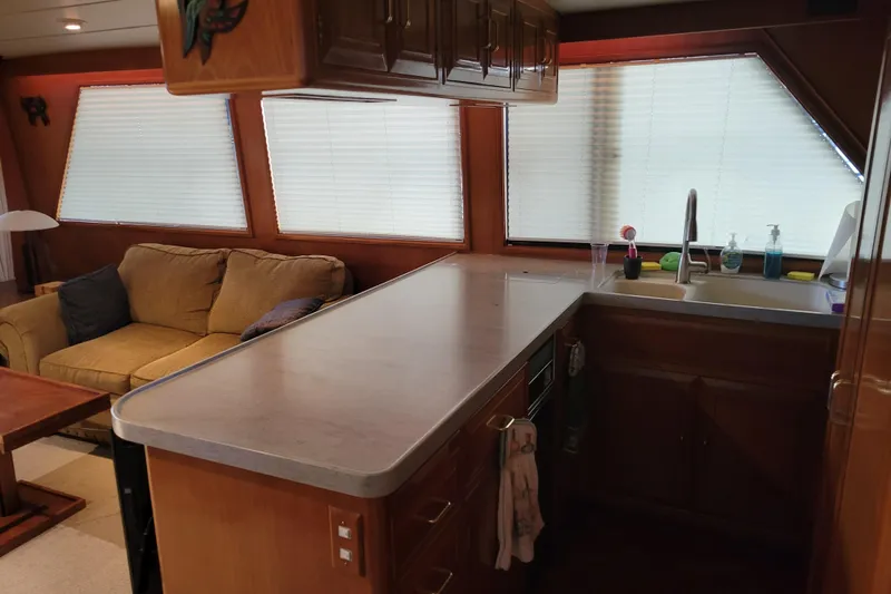 Sumptin Special Yacht Photos Pics Interior of 1990 Ocean Alexander 520 Pilothouse with kitchen and cozy seating area.