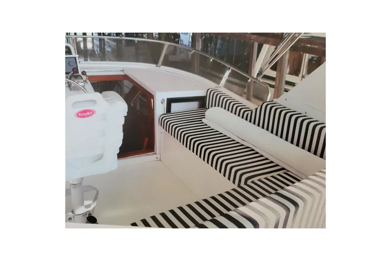 Sumptin Special Yacht Photos Pics 1990 Ocean Alexander 520 Pilothouse interior with striped seating and helm station.