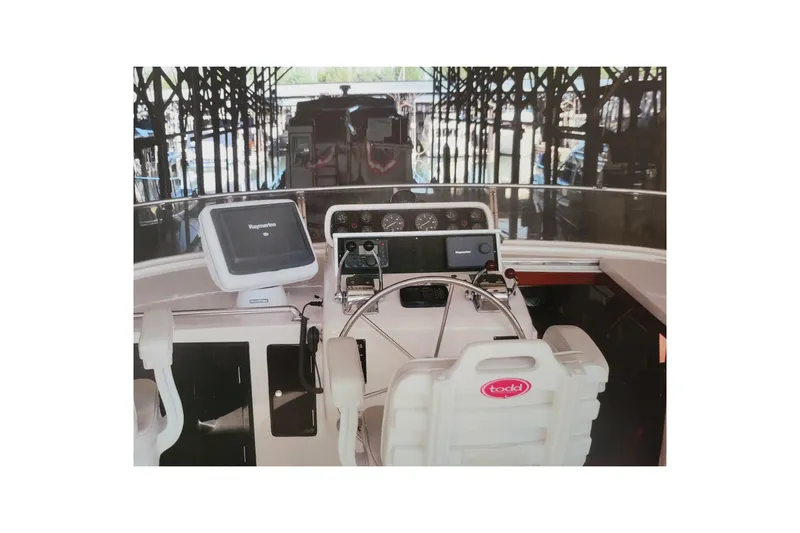 Sumptin Special Yacht Photos Pics Cockpit of 1990 Ocean Alexander 520 Pilothouse with navigation equipment and steering wheel.