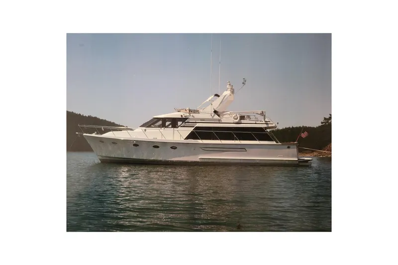 Sumptin Special Yacht Photos Pics 1990 Ocean Alexander 520 Pilothouse yacht on calm water, side view.