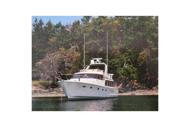 Sumptin Special Yacht Photos Pics 1990 Ocean Alexander 520 Pilothouse yacht anchored near lush forest shoreline.