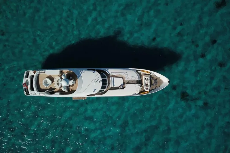 Unforgettable Yacht Photos Pics Aerial view of 2003 Royal Denship M.Y. yacht on clear turquoise water.