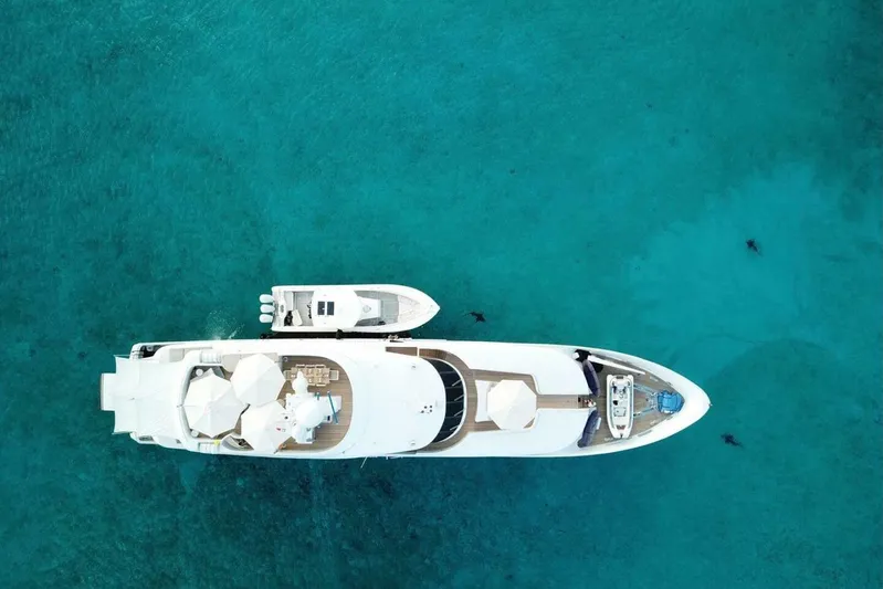 Unforgettable Yacht Photos Pics Aerial view of 2003 Royal Denship M.Y. yacht on clear turquoise water.