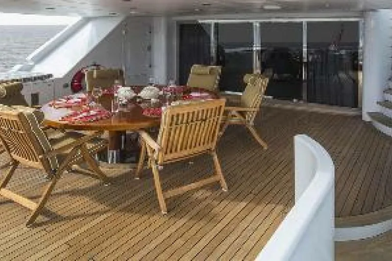 Unforgettable Yacht Photos Pics Luxurious 2003 Royal Denship M.Y. yacht deck with elegant dining setup.