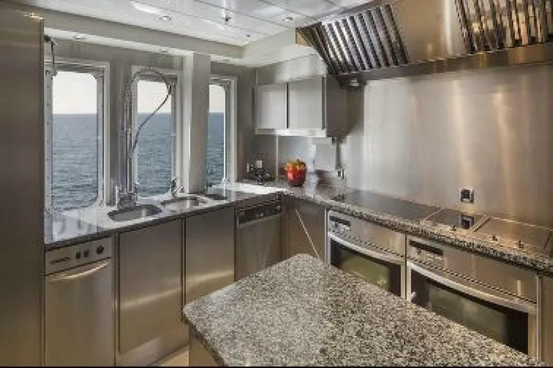 Unforgettable Yacht Photos Pics Luxurious yacht kitchen with stainless steel appliances, granite countertops, and ocean view windows. Royal Denship 2003.