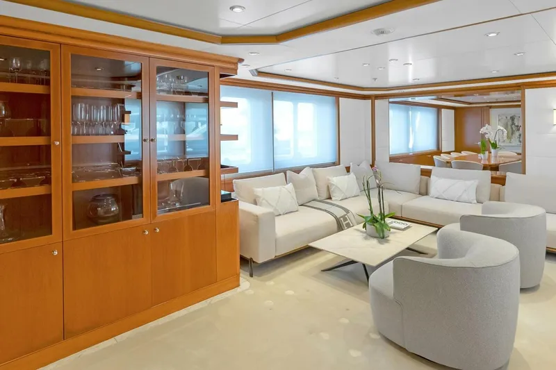 Unforgettable Yacht Photos Pics Luxurious yacht interior with elegant seating, glass cabinet, and modern decor, Royal Denship M.Y. 2003.