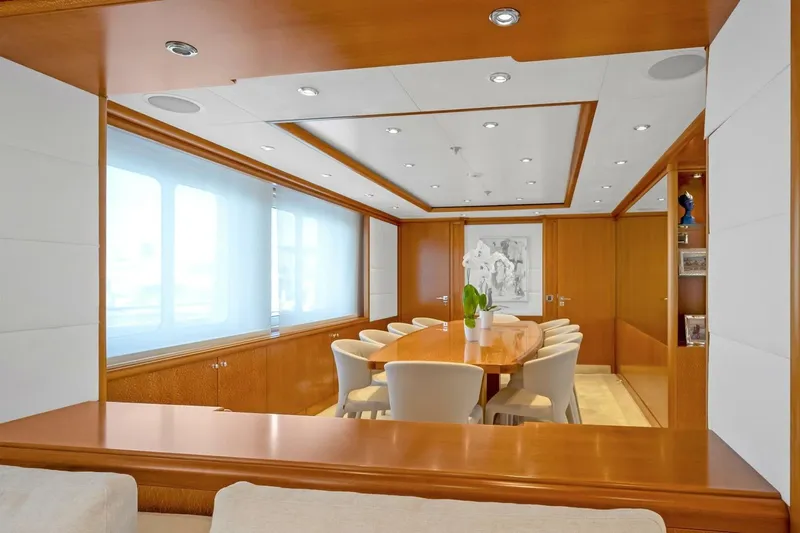 Unforgettable Yacht Photos Pics Luxurious dining area on 2003 Royal Denship M.Y. yacht with elegant wood finishes.