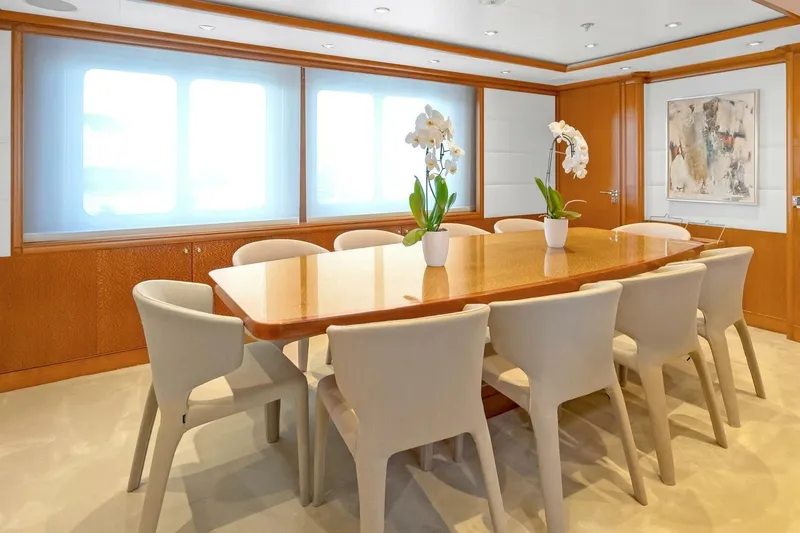 Unforgettable Yacht Photos Pics Luxurious dining area on 2003 Royal Denship M.Y. yacht with elegant decor and seating.