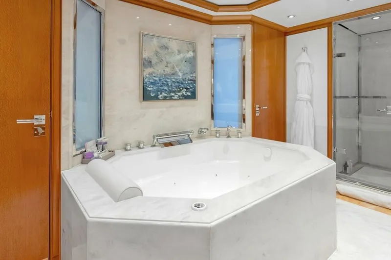 Unforgettable Yacht Photos Pics Luxurious yacht bathroom with marble jacuzzi, modern shower, and elegant decor, Royal Denship M.Y. 2003.