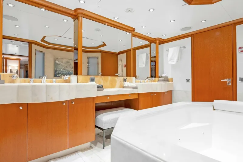 Unforgettable Yacht Photos Pics Luxurious yacht bathroom with wooden cabinetry, marble countertops, and large mirrors, Royal Denship M.Y. 2003.