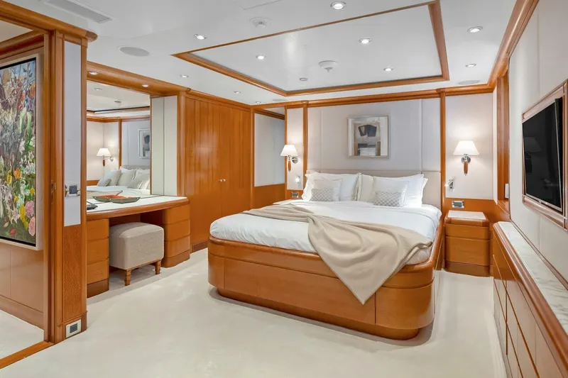Unforgettable Yacht Photos Pics Luxurious yacht bedroom with elegant wood paneling, cozy bed, and modern decor, Royal Denship M.Y. 2003.