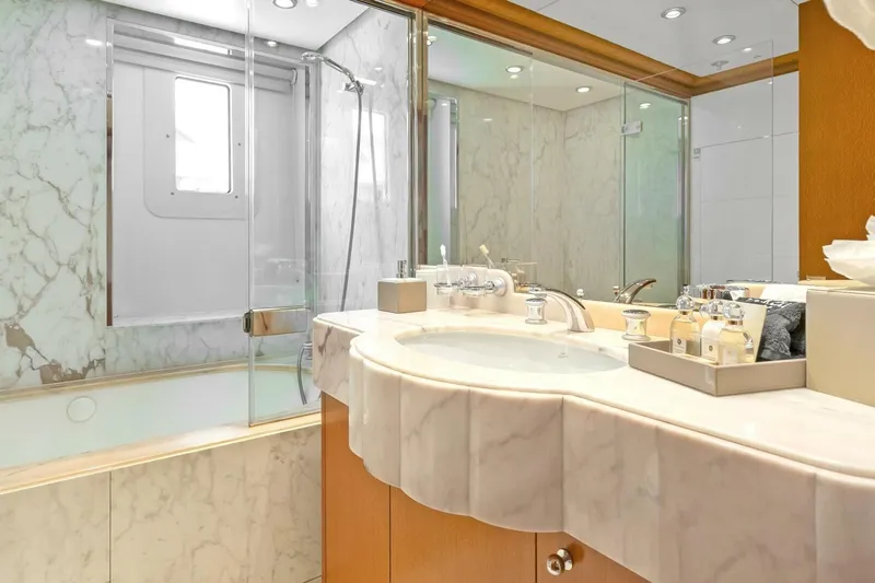 Unforgettable Yacht Photos Pics Luxurious marble bathroom in 2003 Royal Denship M.Y. yacht, featuring elegant fixtures and amenities.