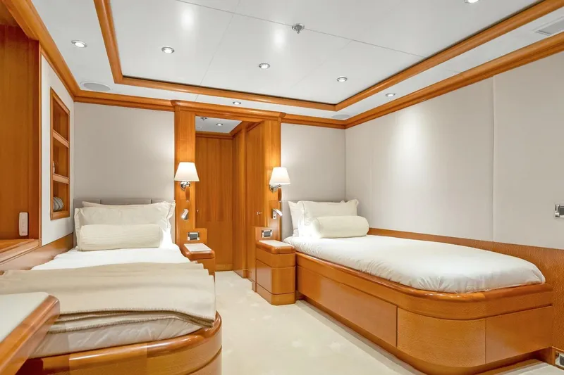Unforgettable Yacht Photos Pics Luxurious twin bedroom on 2003 Royal Denship M.Y. yacht, featuring elegant wood finishes.