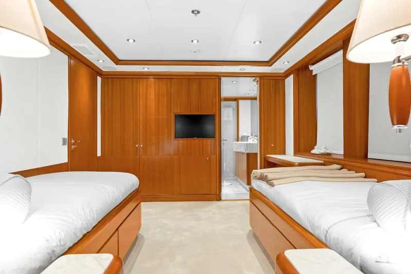Unforgettable Yacht Photos Pics Luxurious 2003 Royal Denship M.Y. yacht cabin with twin beds and elegant wood paneling.
