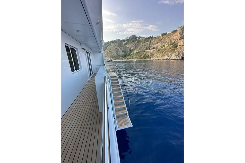 Unforgettable Yacht Photos Pics Luxurious 2003 Royal Denship M.Y. yacht with scenic coastal view.