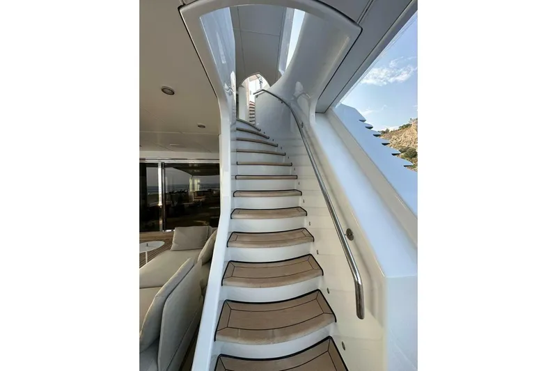 Unforgettable Yacht Photos Pics Elegant staircase on 2003 Royal Denship M.Y. yacht, featuring sleek design and modern interior.