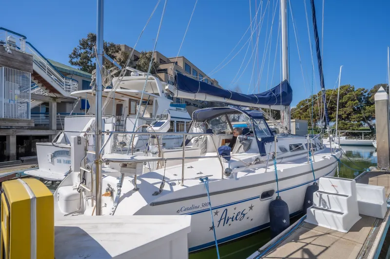 Aries Yacht Photos Pics Catalina 380 sailboat docked at marina, 2002 model, sunny day, blue canvas covers.