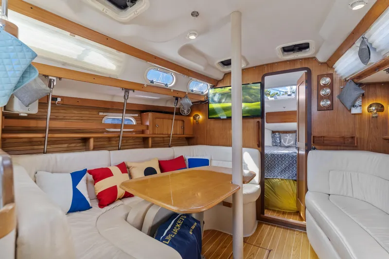 Aries Yacht Photos Pics Interior of 2002 Catalina 380 sailboat with cozy seating and nautical decor.