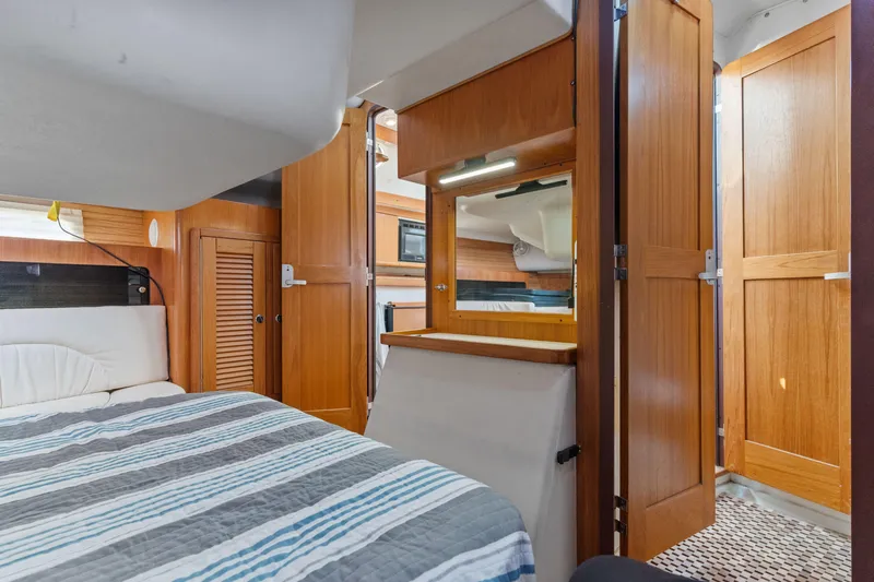 Aries Yacht Photos Pics Interior of 2002 Catalina 380 sailboat with cozy cabin and wooden finishes.