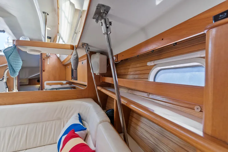 Aries Yacht Photos Pics Interior of 2002 Catalina 380 sailboat with wooden accents and cozy seating area.