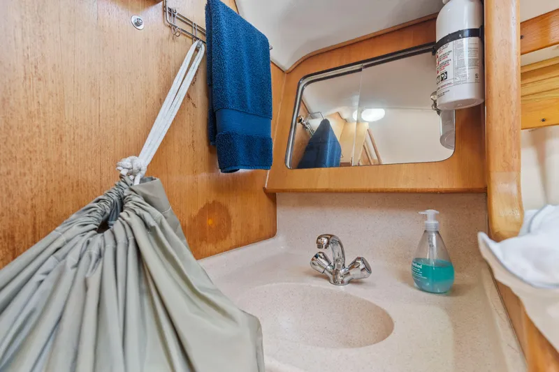 Aries Yacht Photos Pics Catalina 380 yacht bathroom with sink, mirror, and toiletries, 2002 model.