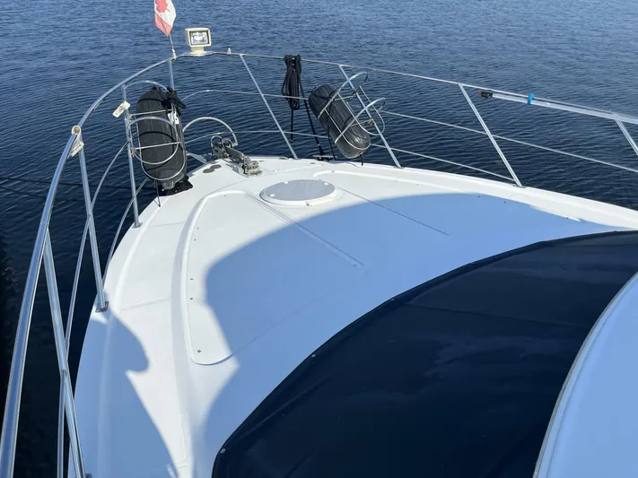  Yacht Photos Pics 2003 Carver 444 Cockpit Motor Yacht bow with railings and water view.