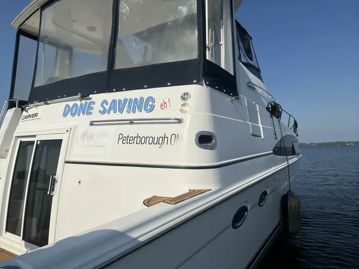  Yacht Photos Pics 2003 Carver 444 Cockpit Motor Yacht docked, featuring "Done Saving" text, Peterborough ON.