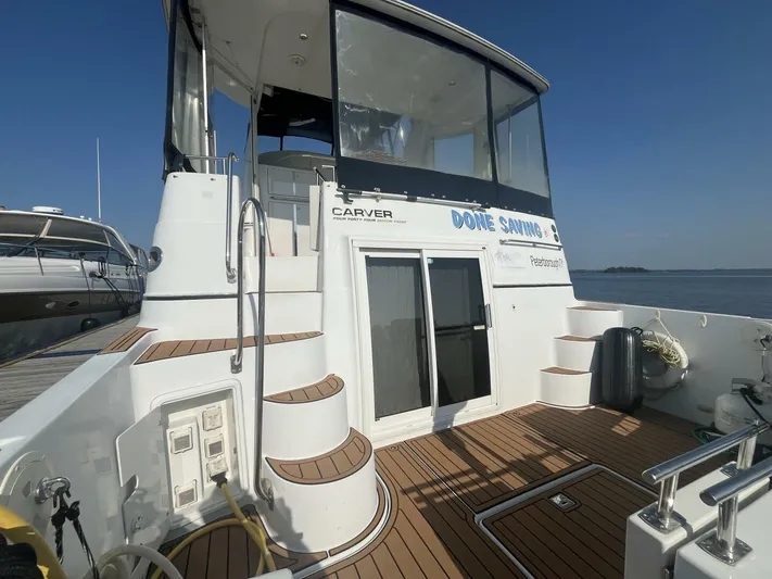  Yacht Photos Pics 2003 Carver 444 Cockpit Motor Yacht docked, featuring spacious deck and elegant design.