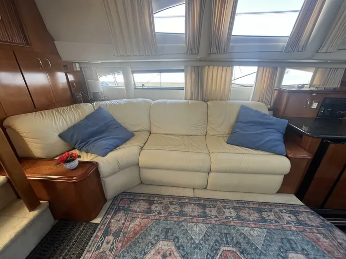  Yacht Photos Pics Luxurious interior of 2003 Carver 444 Cockpit Motor Yacht with cream sofa and blue cushions.