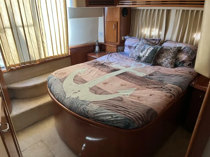  Yacht Photos Pics Luxurious bedroom in 2003 Carver 444 Cockpit Motor Yacht with nautical-themed bedding.