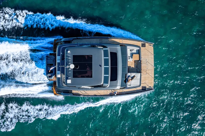 Skip The Wait - Trade Ins Considered Yacht Photos Pics Aerial view of 2026 Sunreef 60 Power yacht cruising on turquoise waters.
