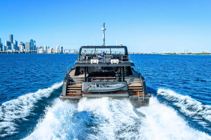 Skip The Wait - Trade Ins Considered Yacht Photos Pics Sunreef 60 Power yacht cruising near city skyline, 2026 model.