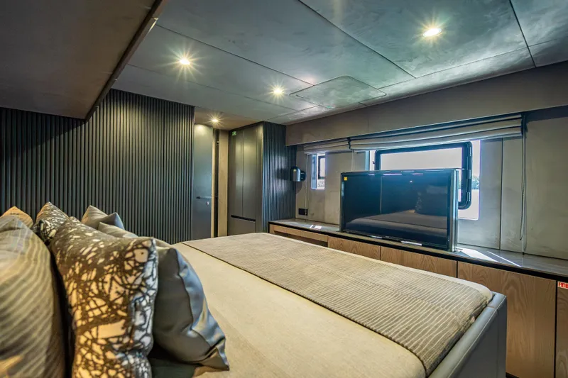 Skip The Wait - Trade Ins Considered Yacht Photos Pics Luxurious Sunreef 60 Power 2026 yacht bedroom with modern decor and large window.