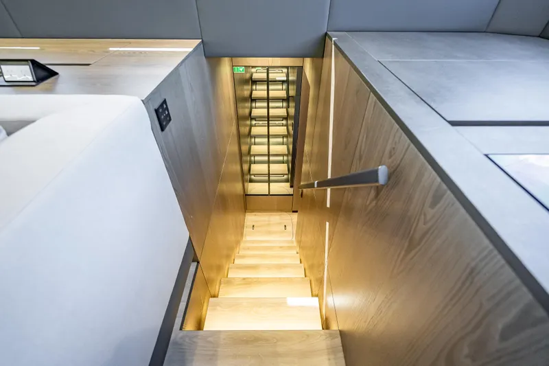 Skip The Wait - Trade Ins Considered Yacht Photos Pics Modern interior staircase on 2026 Sunreef 60 Power yacht, featuring sleek wooden design.