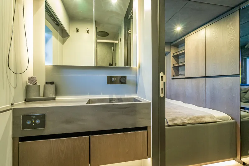 Skip The Wait - Trade Ins Considered Yacht Photos Pics Luxurious interior of 2026 Sunreef 60 Power yacht featuring modern bathroom and bedroom.