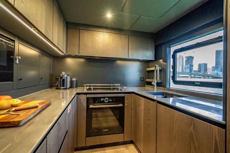 Skip The Wait - Trade Ins Considered Yacht Photos Pics Modern kitchen interior of 2026 Sunreef 60 Power yacht with cityscape view.