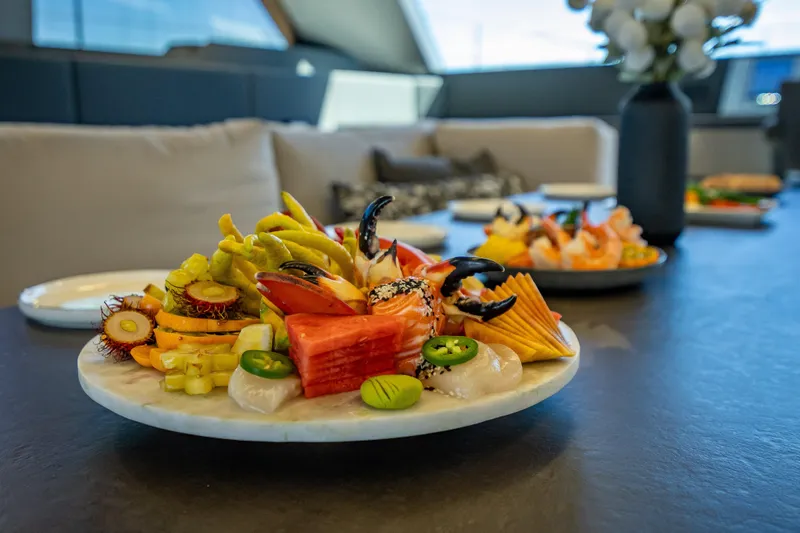 Skip The Wait - Trade Ins Considered Yacht Photos Pics Luxurious dining setup on 2026 Sunreef 60 Power yacht with gourmet seafood platter.
