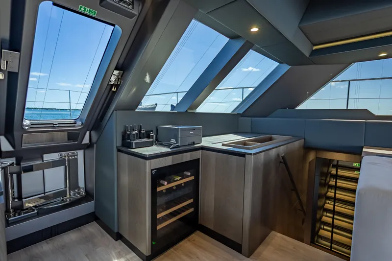 Skip The Wait - Trade Ins Considered Yacht Photos Pics Luxurious interior of 2026 Sunreef 60 Power yacht with modern kitchen and panoramic windows.