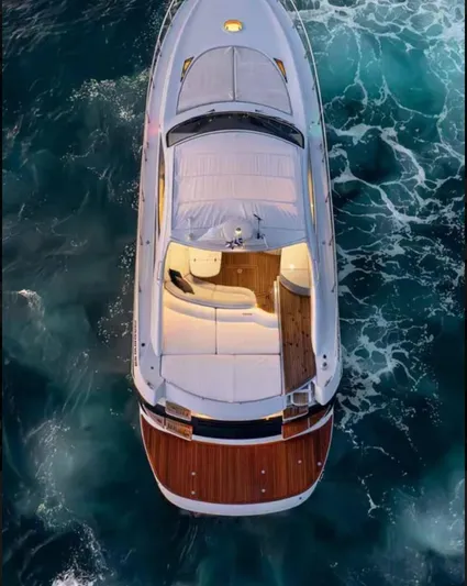 Mira Yacht Photos Pics 2002 Pershing 52' yacht cruising on vibrant ocean waters, aerial view.