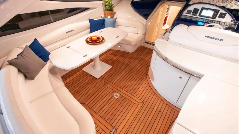 Mira Yacht Photos Pics Luxurious interior of a 2002 Pershing 52' yacht with elegant seating and wooden flooring.
