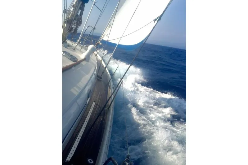  Yacht Photos Pics Sailing on a 1996 Beneteau 50 yacht, cutting through ocean waves.