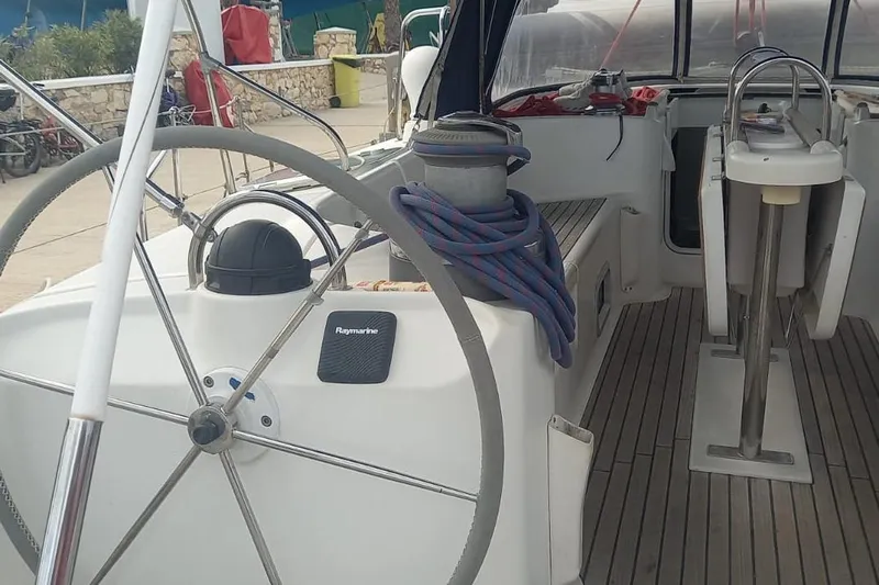  Yacht Photos Pics Cockpit of 1996 Beneteau 50 sailboat with steering wheel and nautical equipment.