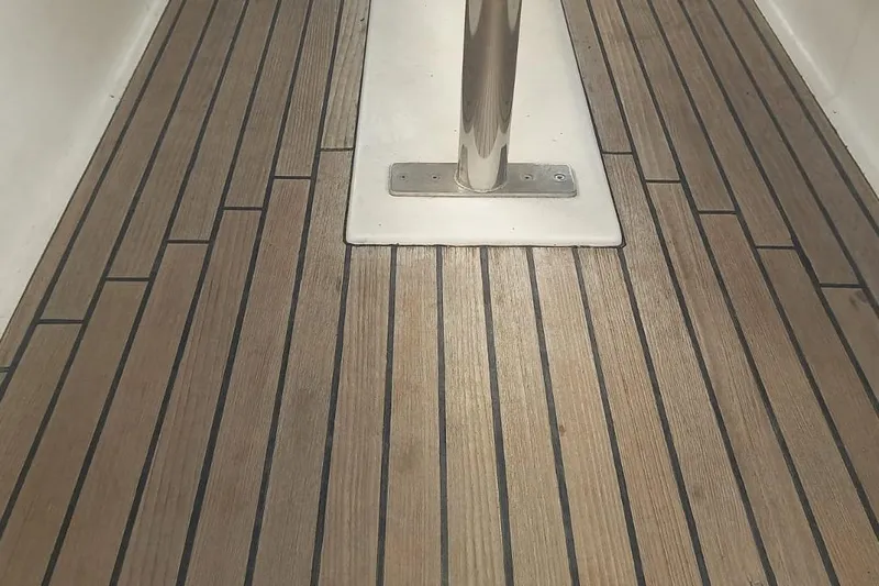  Yacht Photos Pics Teak deck of 1996 Beneteau 50 sailboat, featuring polished metal support.