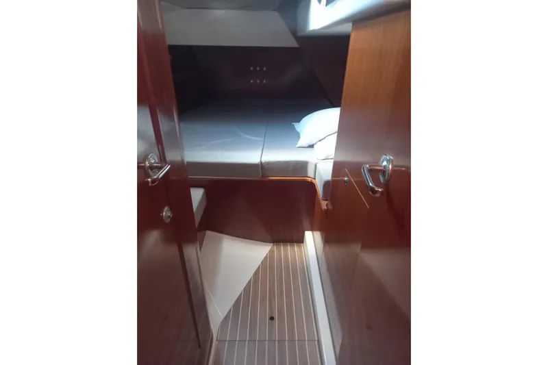  Yacht Photos Pics 1996 Beneteau 50 yacht interior cabin with wooden finish and cozy bed.