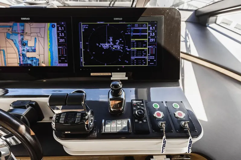 Majestic Moments Yacht Photos Pics Control panel of 2019 Azimut Grande 27 METRI yacht with navigation screens and controls.