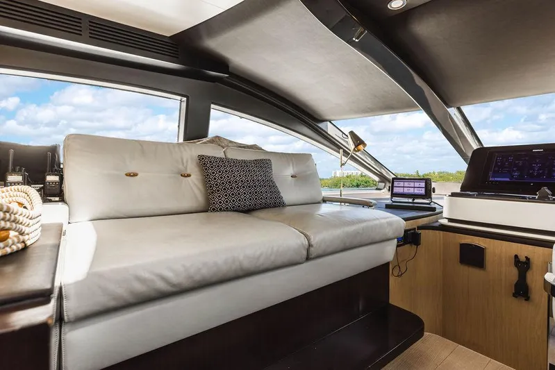 Majestic Moments Yacht Photos Pics Luxurious interior of 2019 Azimut Grande 27 METRI yacht with plush seating and modern controls.