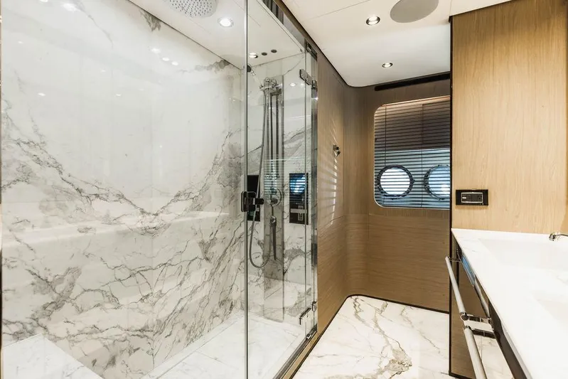 Majestic Moments Yacht Photos Pics Luxurious marble bathroom in 2019 Azimut Grande 27 METRI yacht with glass shower enclosure.